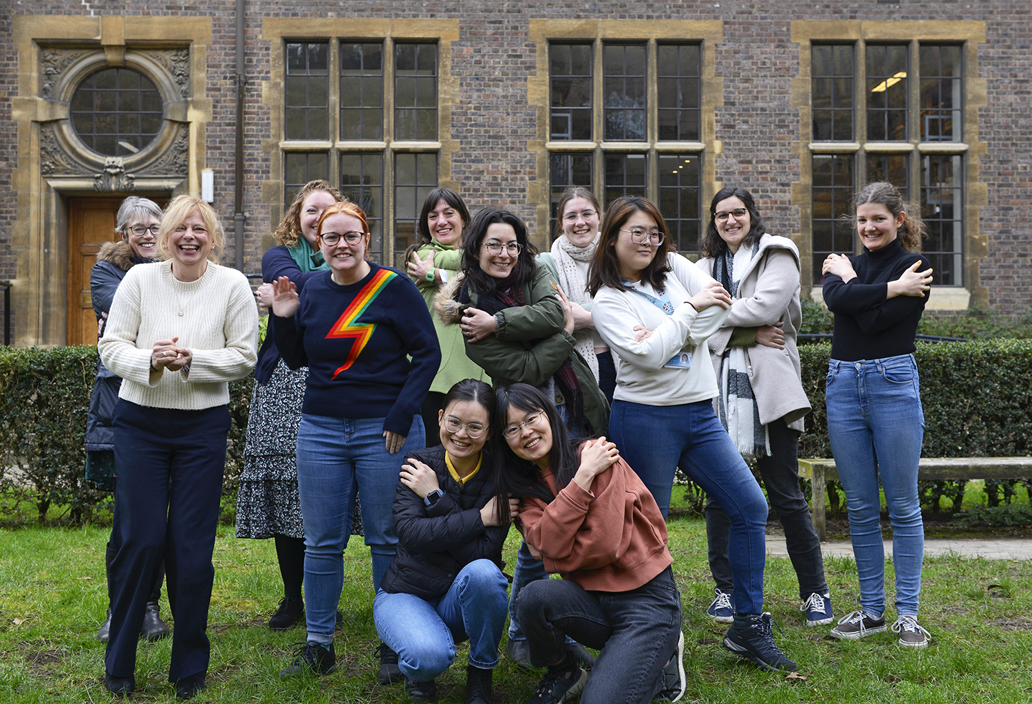 Members of staff and students do the womens day hug fun version