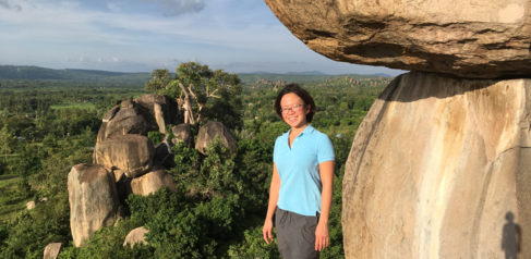 Trisna Tungadi on Kit Mikayi rock in Kenya when she worked with John Carr on a postdoctoral project in collaboration with bean growers in Kenya.