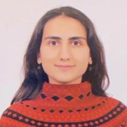 A feminine presenting person with black and a red knit jumper