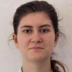 A feminine presenting person with brown hair