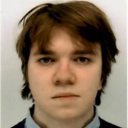 A masculine presenting person with brown hair