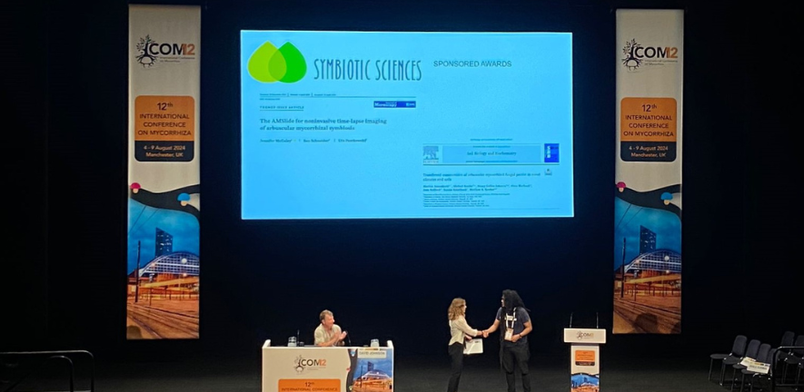 Jen McGaley receiving her award at ICOM 2024